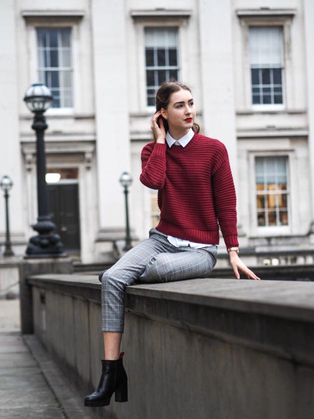 Burgundy knitwear and grey tailoring in the city
